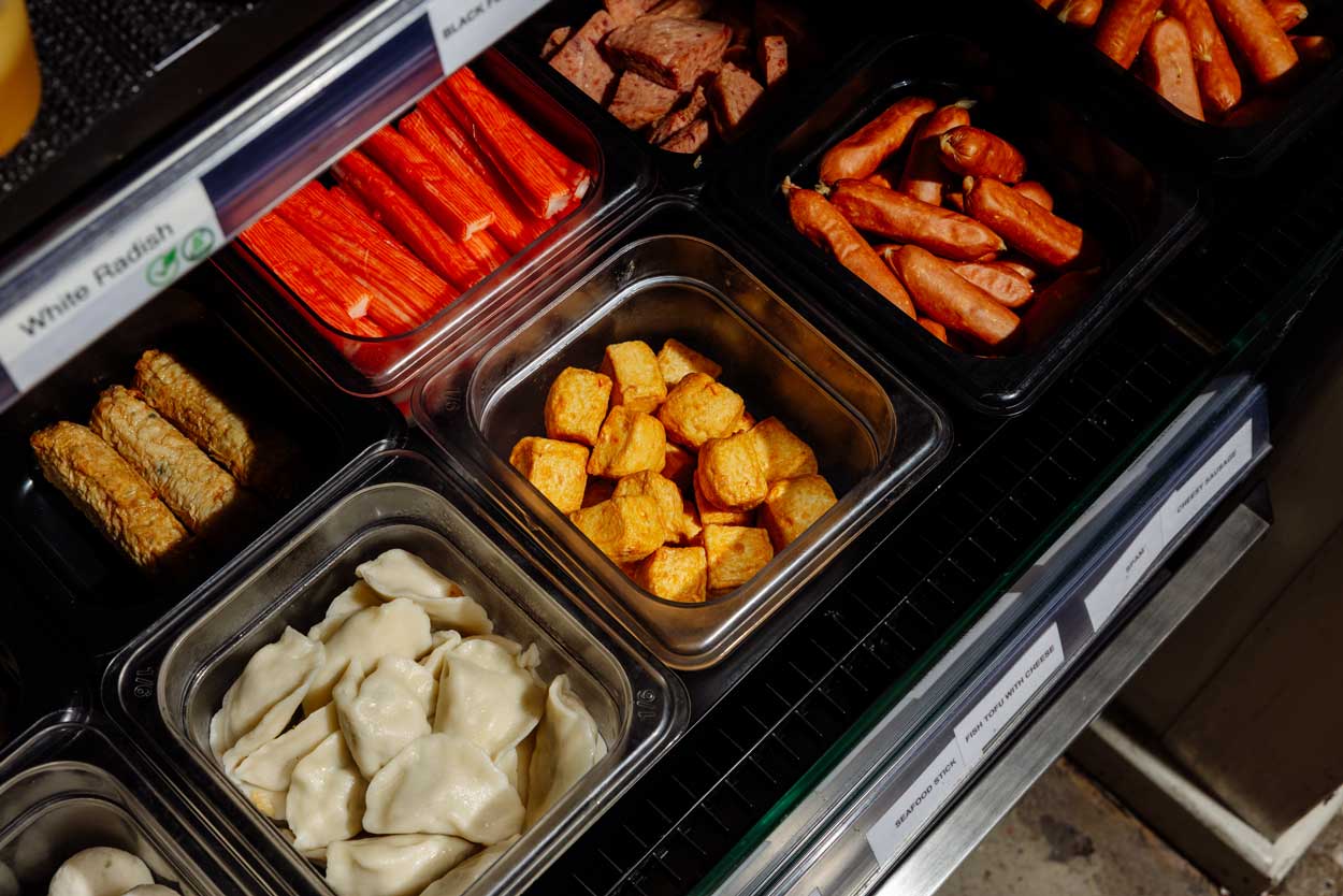 Steaming hotpot broth bubbling in a pot.