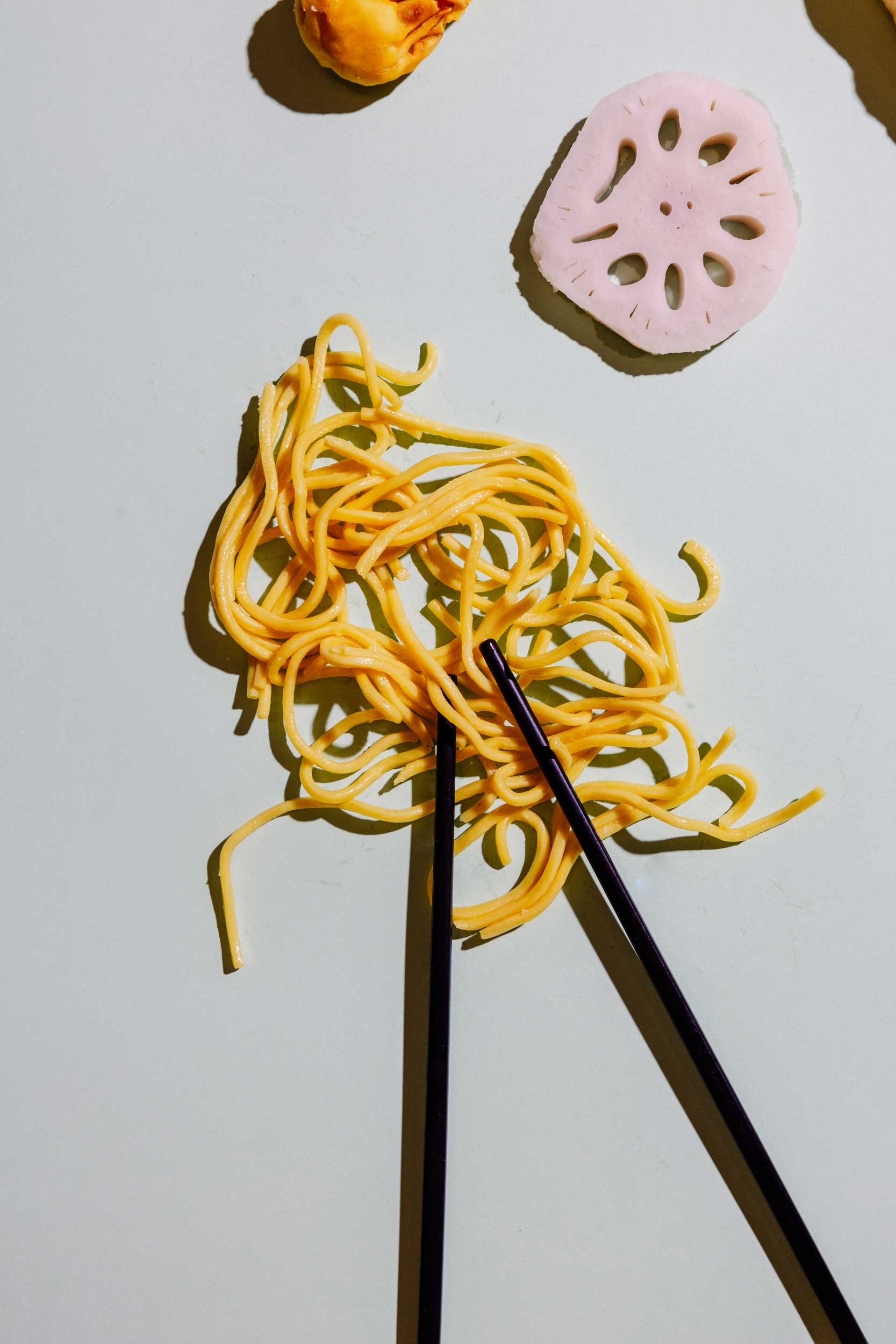 A chef tossing ingredients in a wok with flames.